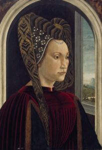 Portrait of Clarice Orsini de Medici by Ghirlandaio (1490s). She sits in front of an arched window frame, wearing a costly red velvet fur-lined robe over a costly black gown. The picture is dominated by her tall V-shaped hat, patterned in costly brocades of black and gold, and edged and embroidered with many pearls. Her expression is calm and unsmiling as she sits shown at 3/4 view. She has the fashionably high forehead and barely-visible eyebrows of the period, and vivid dark eyes.