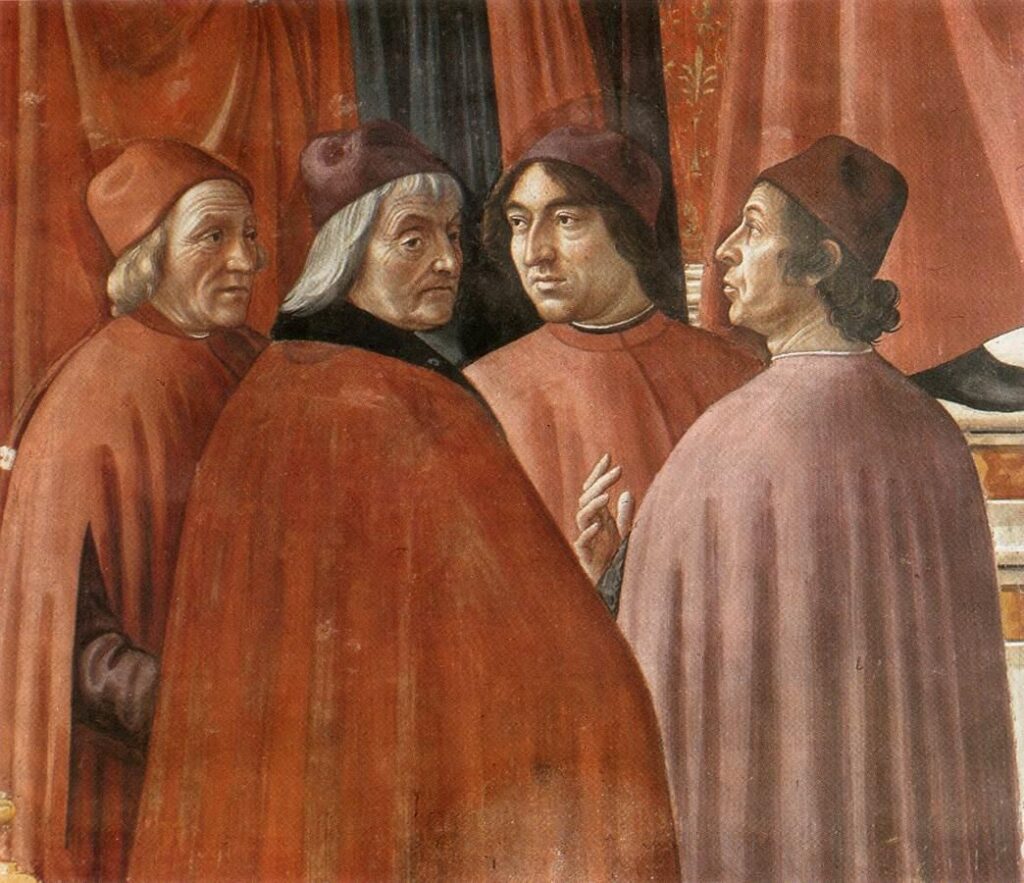 Detail from a Ghirlandaio fresco showing four of the famous scholars from the circle around Lorenzo in Florence wearing the typical Florentine garments of long red cloaks down past the knee (various shades of red) open down the front and at the sides, over sleeved under-robes. They also wear the acorn-shaped red felt caps common at the period, especially for a scholar (slightly less costly than Lorenzo's chaperon.)