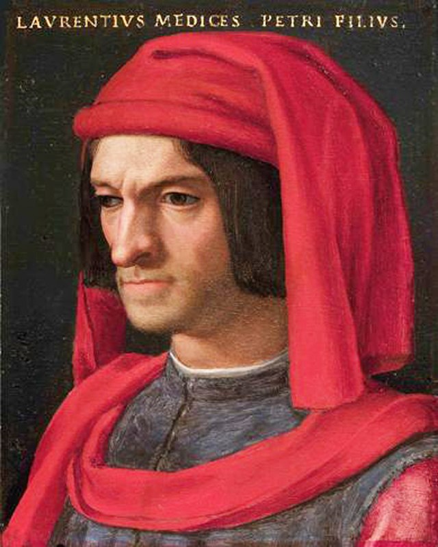 Lorenzo de Medici, dressed like merchant scum. He's wearing a very expensive red wool chaperon hat (whose dangling red tip drapes around his shoulders like a scarf). Under that you can see his shoulders have red sleeves, but the body of the garment covering his chest and back is black and pleated. These are very expensive clothes made of costly vividly bright fabrics, but they're what merchants wear, *not* what nobles wear.