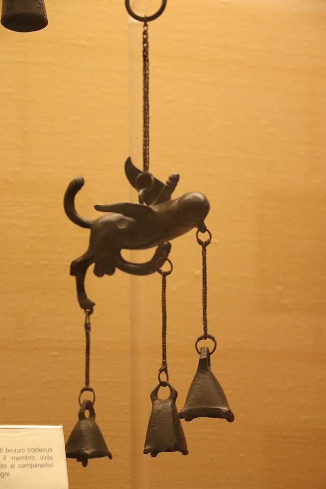 From the same museum collection, an ancient Roman bronze flying phallus, with additional phalluses coming off of it, with bells hanging from it, designed to hang like a wind chime or a bell on a store's front door.