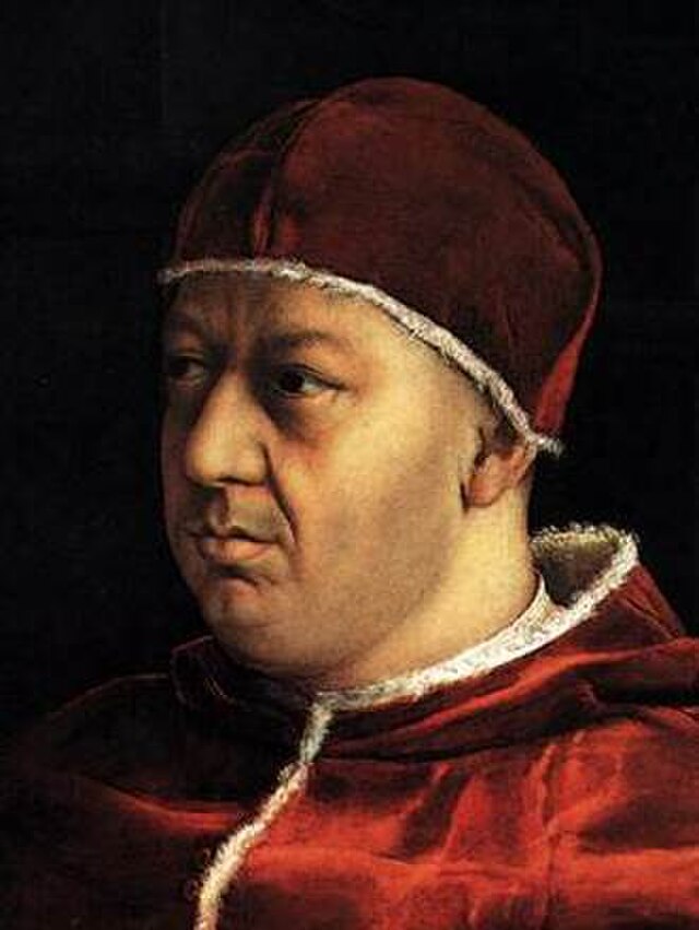 Detail from Raphael's portrait of Pope Leo X, that is Giovanni de Medici, Lorenzo's second son. Leo's face looks young, late 30s or start of 40s, a bit chubby, with some care lines on his brow but relaxed. He wears the iconic red velvet skullcap and red velvet cape lined with white fur that we associated with Renaissance popes.